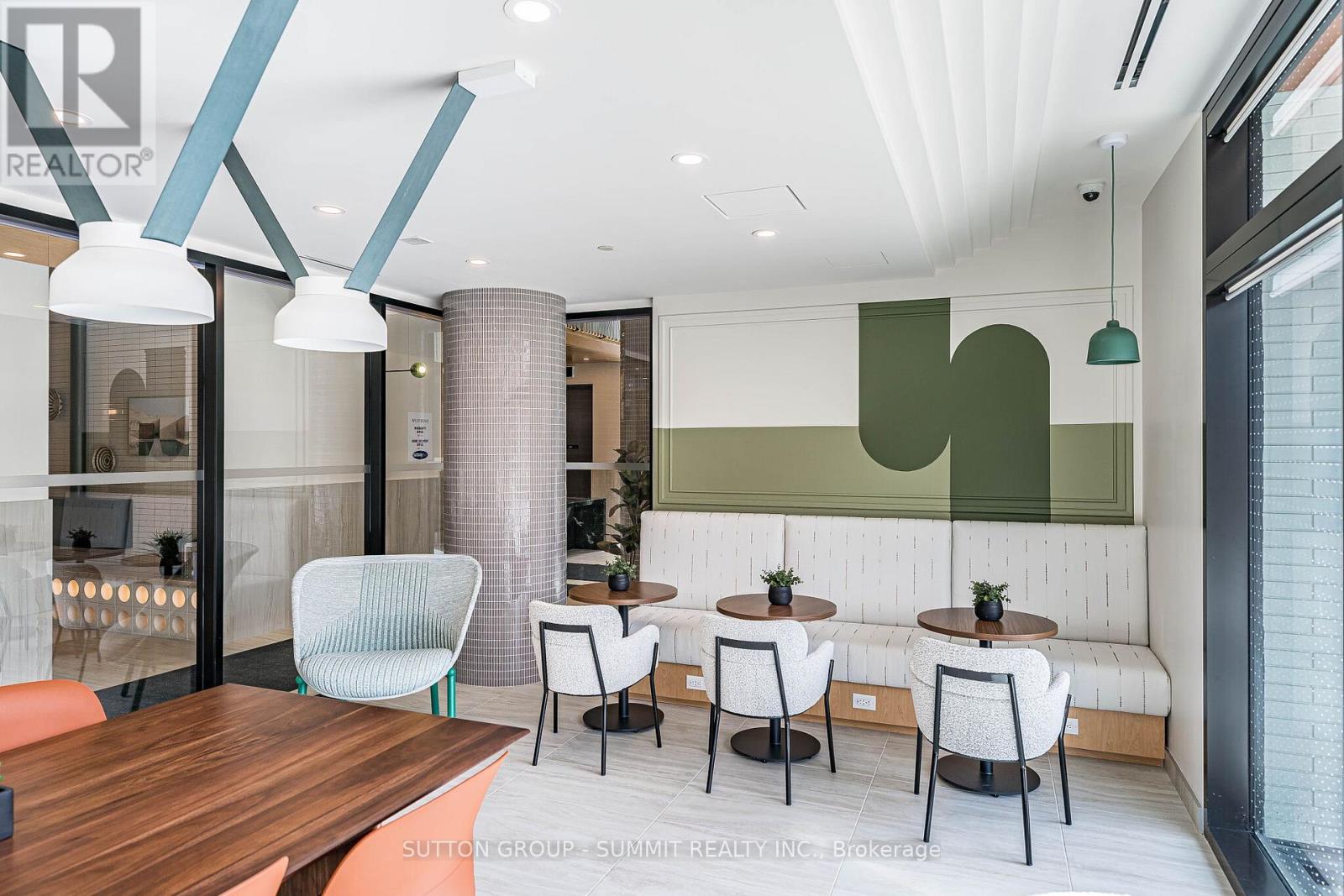 A modern dining area with a wooden table and white chairs.