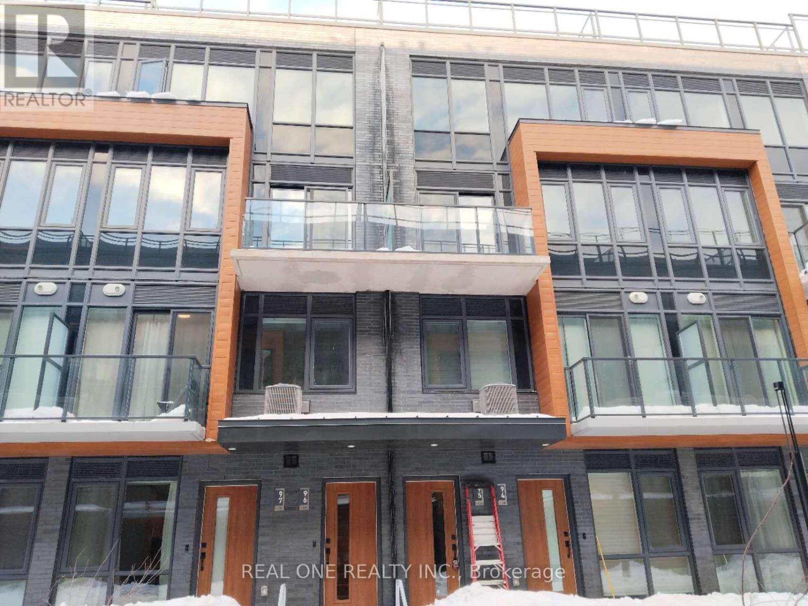 A building with the words REAL ONE REALTY INC. BROKERAGE on the front.