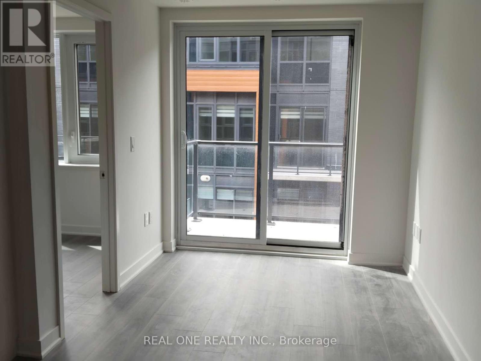 A room with a sliding door leading to a balcony.