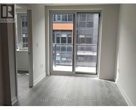 A room with a sliding door leading to a balcony.
