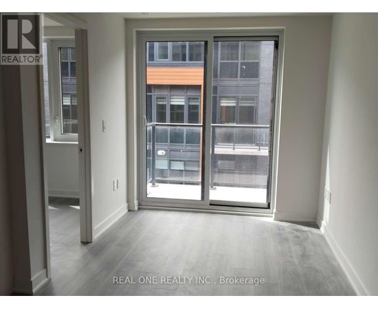 A room with a sliding door leading to a balcony.