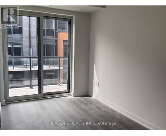 A room with a sliding glass door leading to a balcony.