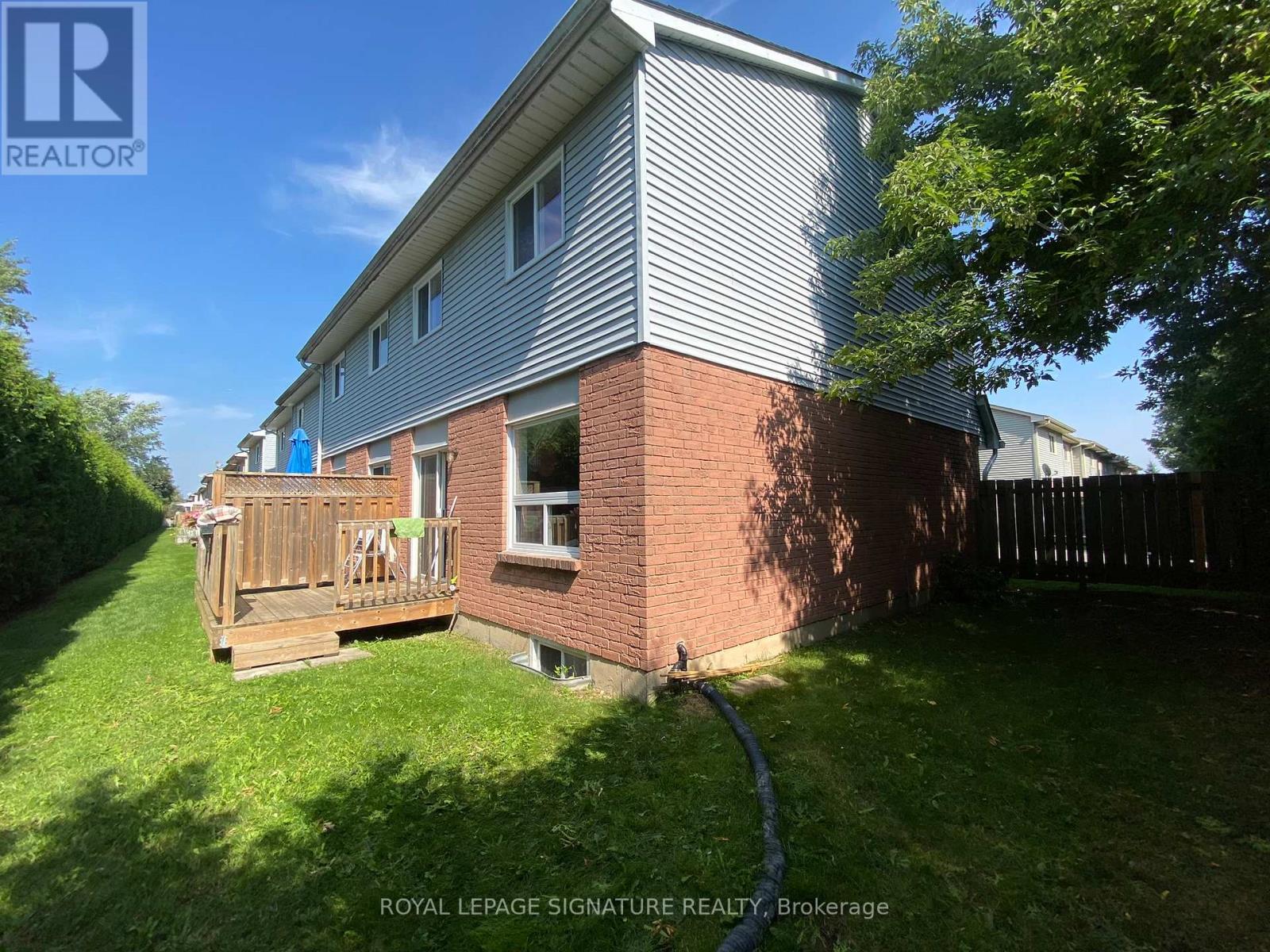 A house with a grey roof and a wooden deck.