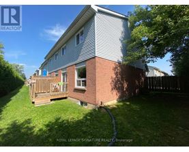 A house with a grey roof and a wooden deck.