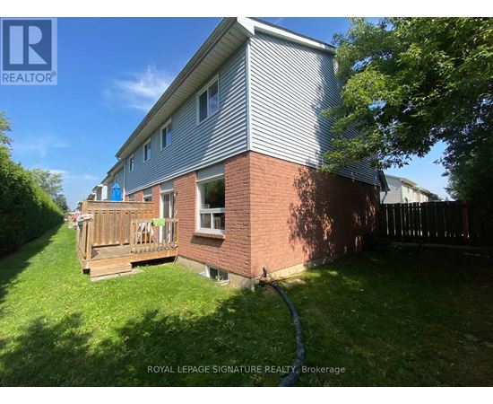 A house with a grey roof and a wooden deck.