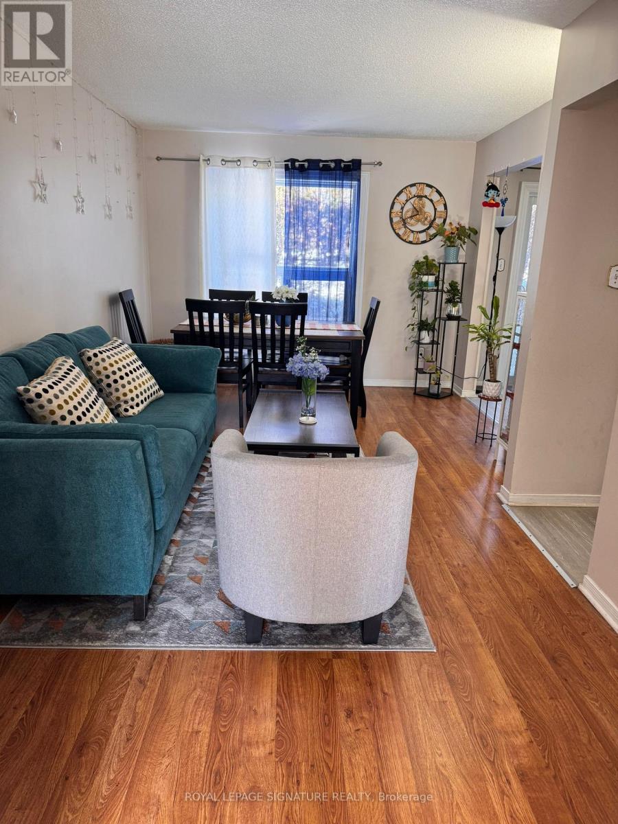 A living room with a green couch and a wooden floor.