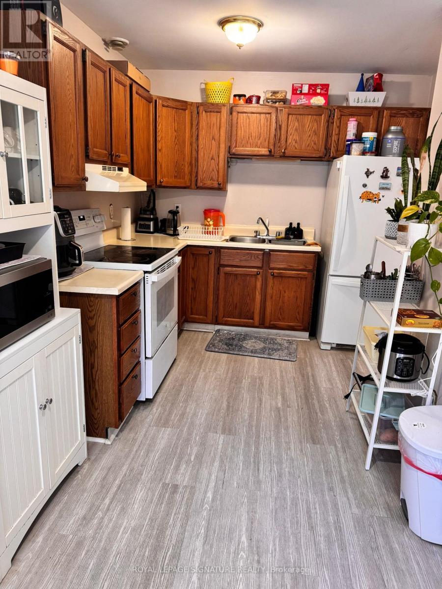 A kitchen with wooden cabinets and a white refrigerator.