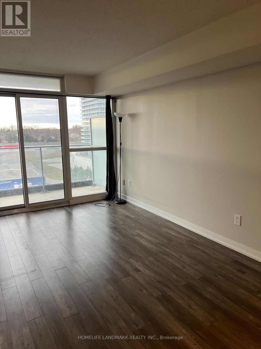 A room with a sliding glass door leading to a balcony.