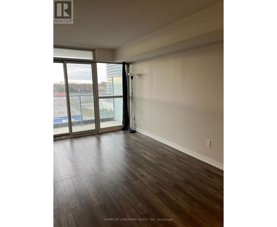 A room with a sliding glass door leading to a balcony.