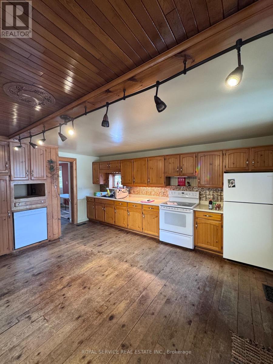 A kitchen with wooden cabinets and a white refrigerator.