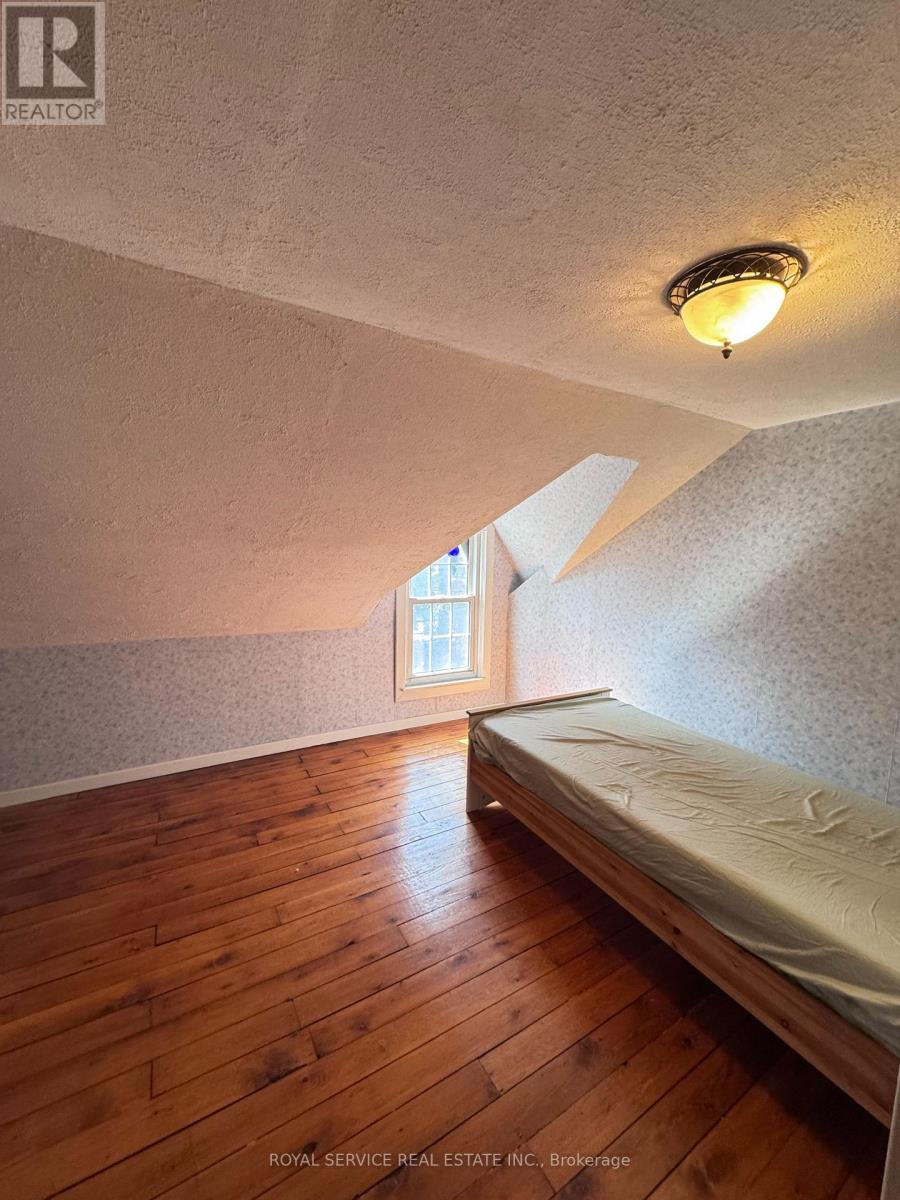 A bedroom with a bed and a window.