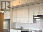 A kitchen with white cabinets and a stainless steel counter.