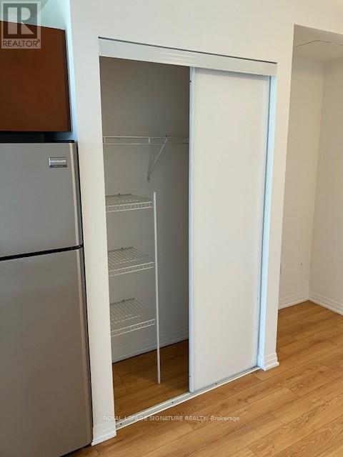 A white refrigerator with a white door is in a kitchen.