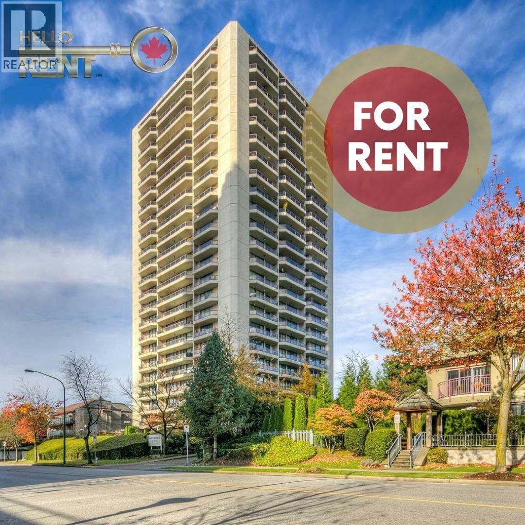 A tall building with a sign that says "FOR RENT" in front of it.