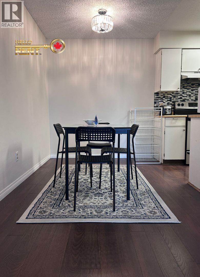 A dining room with a table and chairs.