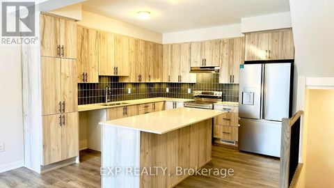 A kitchen with wooden cabinets and a white island.