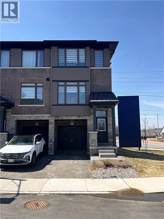 A modern two-story house with a white car parked in front.
