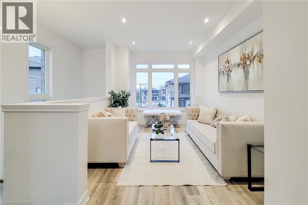 A living room with a white sofa set and a coffee table in the middle.