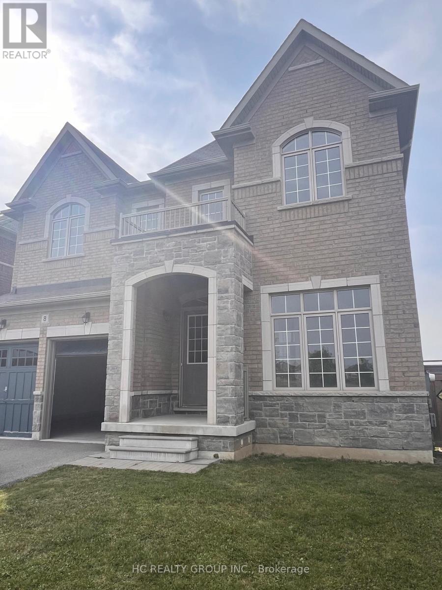 A large house with a stone facade and a large arched entrance.