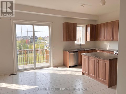 A kitchen with wooden cabinets and a marble countertop.