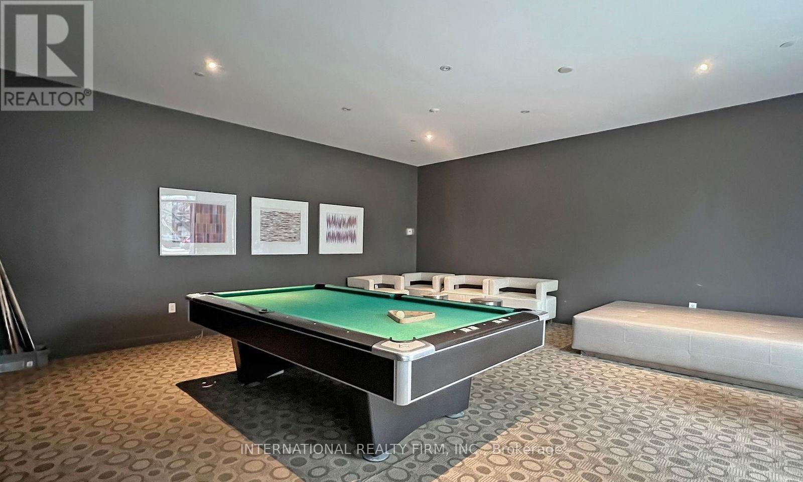A pool table in a room with a carpeted floor.