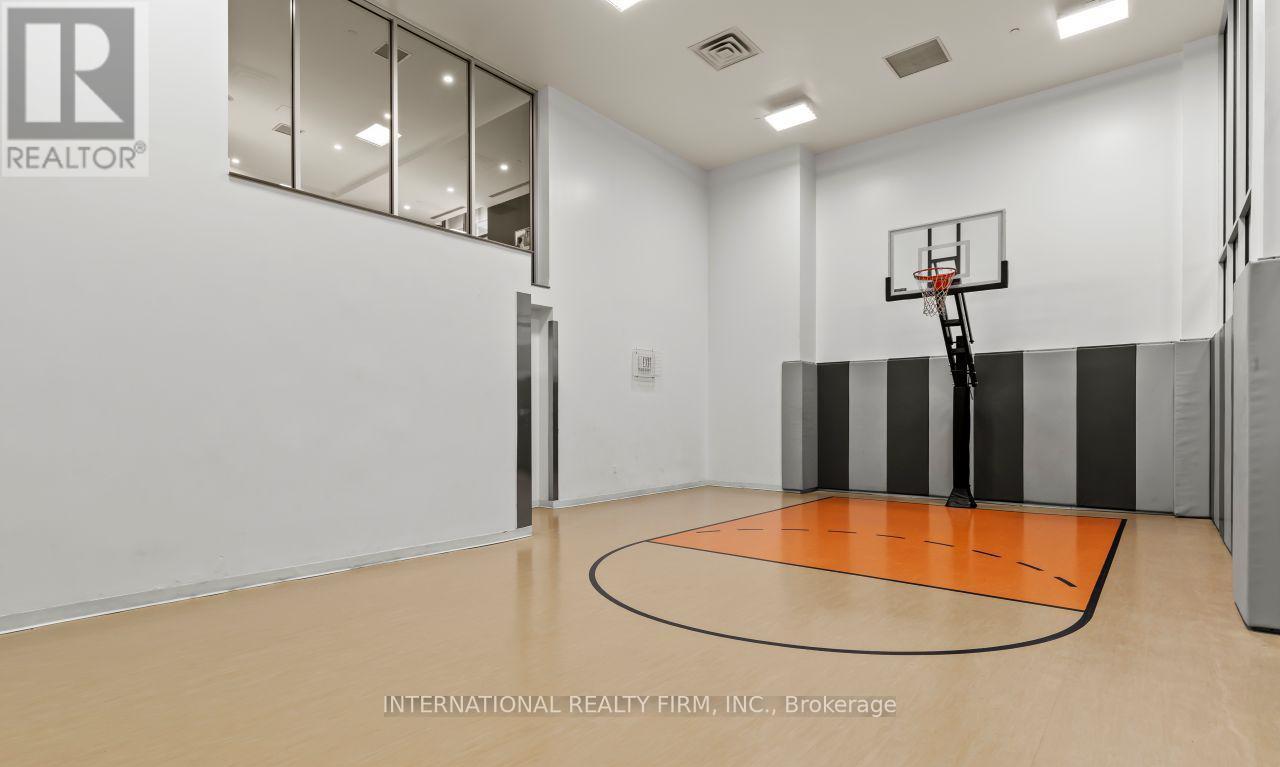 A basketball court inside a spacious room.
