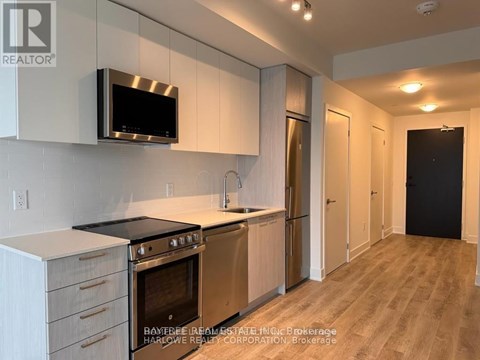 A modern kitchen with a stainless steel oven and microwave.