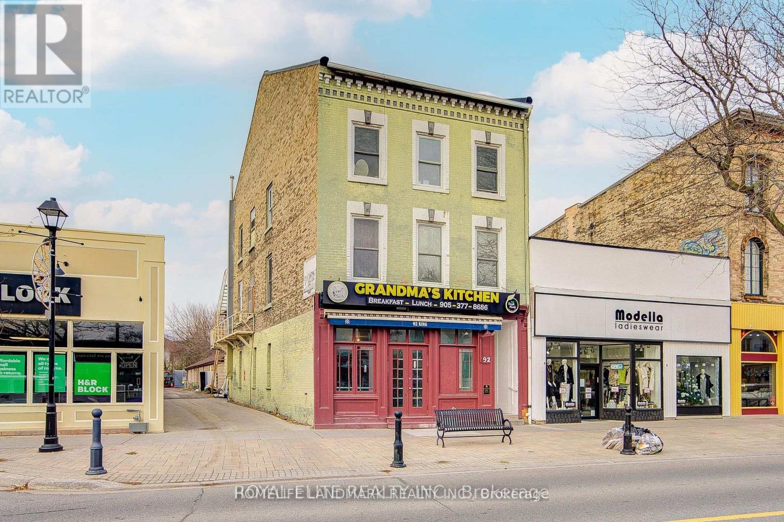 A street view of a building with a sign that says "Grandma's Kitchen".