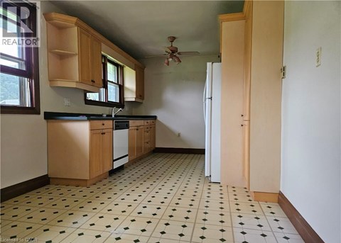 A kitchen with a black and white checkered floor.