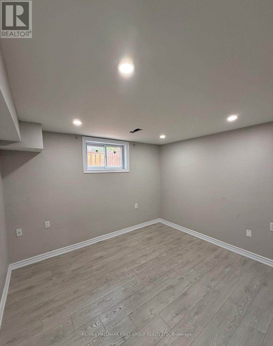 A room with a window and wooden flooring.