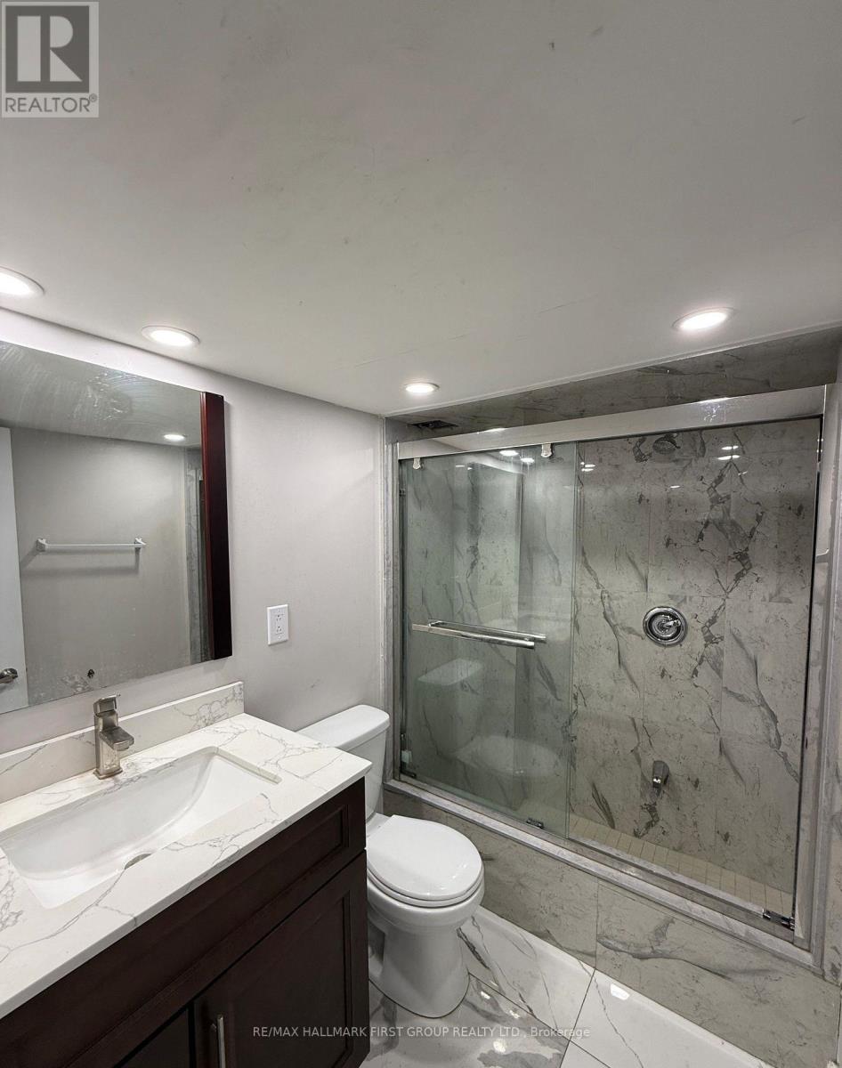 A bathroom with a sink, toilet and shower.