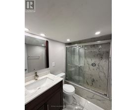 A bathroom with a sink, toilet and shower.