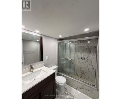 A bathroom with a sink, toilet and shower.