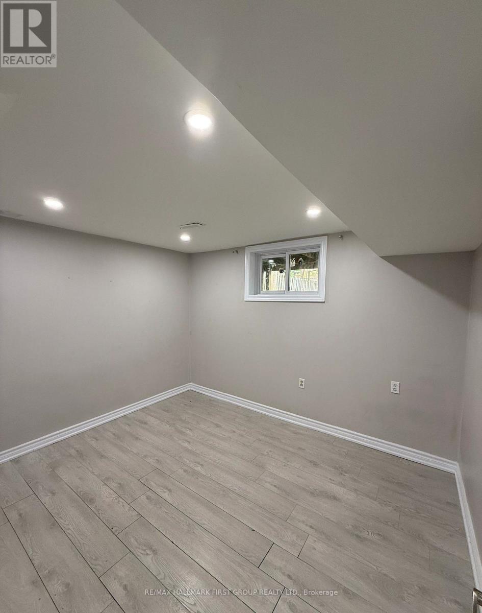 A room with a window and wooden flooring.
