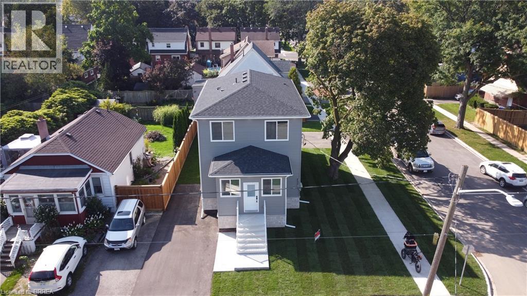 A house with a grey roof and a white car parked in front.