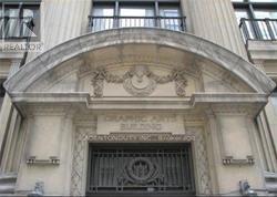 A building with a large arched entrance and a sign that says "REALTOR".