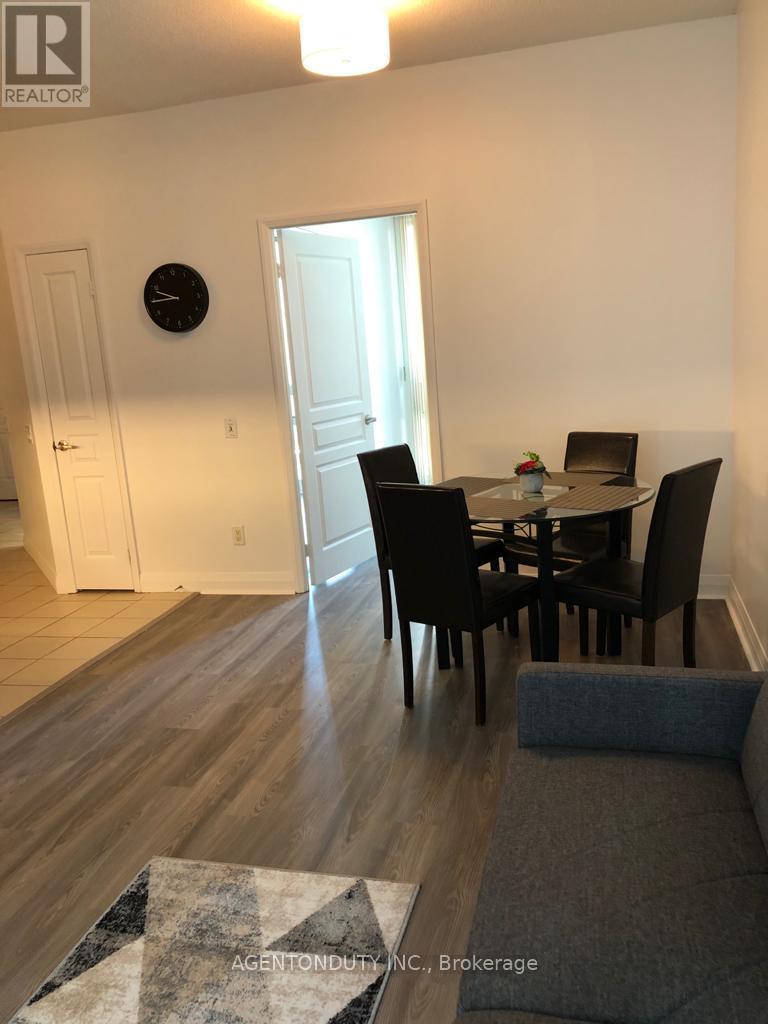 A dining room with a table set for four.