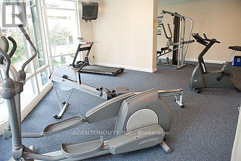 A gym with exercise equipment including a stationary bike and a treadmill.