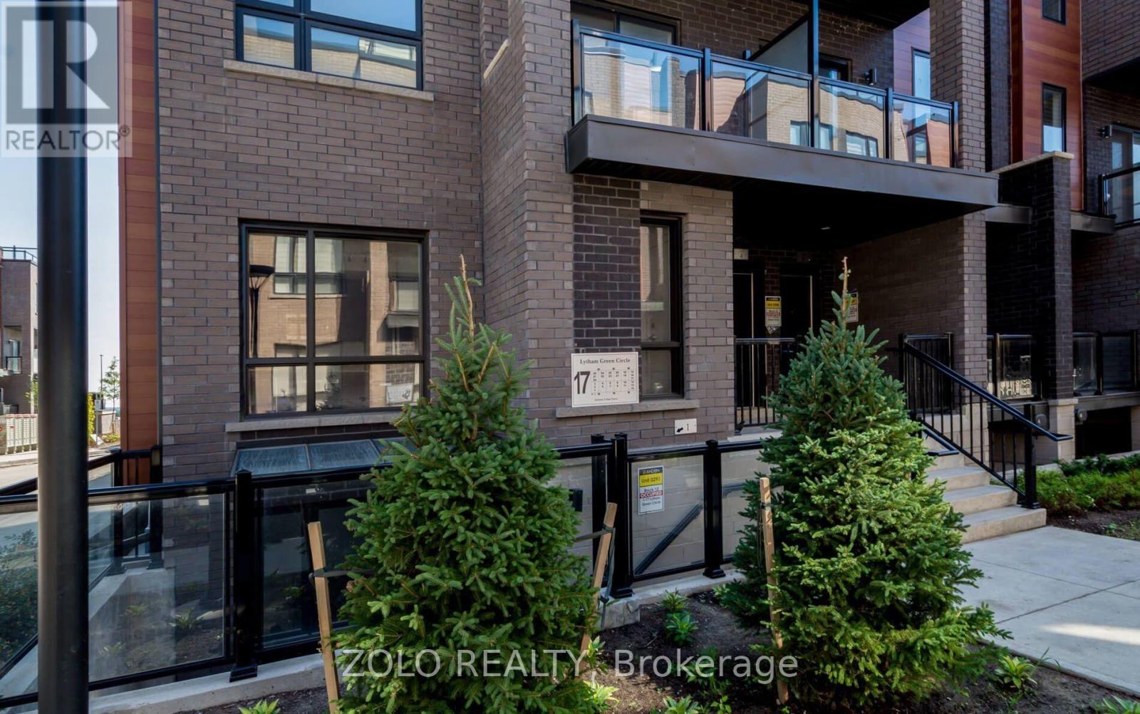 A modern building with a glass entrance and a balcony.