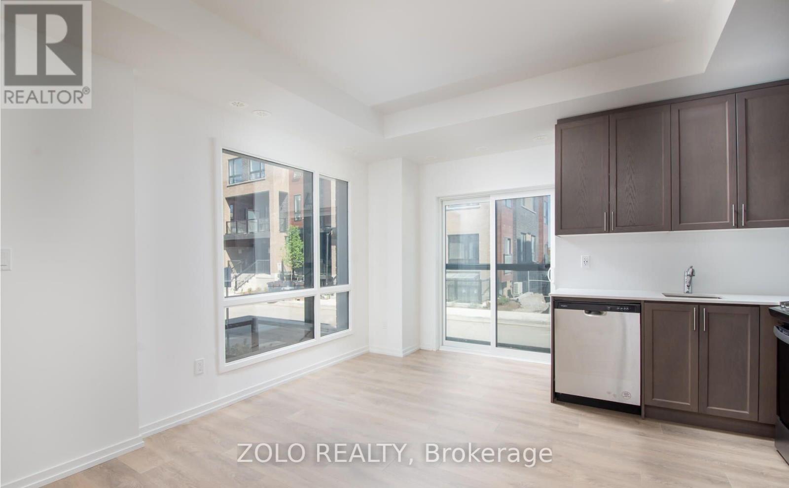 A real estate listing image of a kitchen and living room.