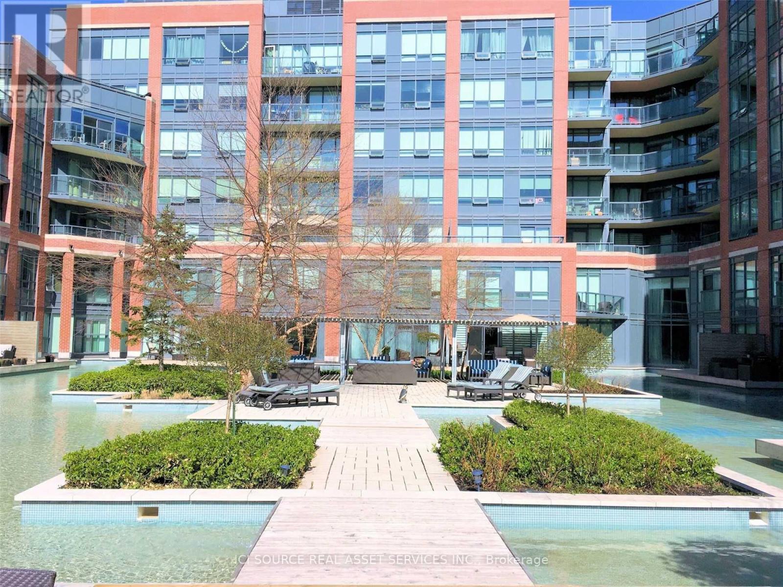 A modern building with a pool in front.