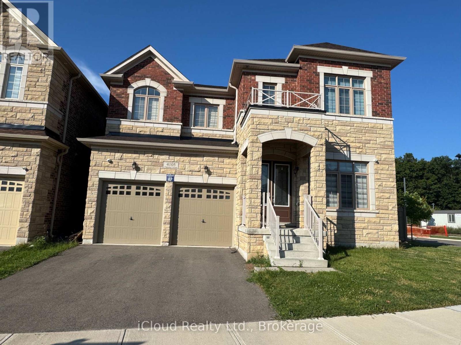 A two-story house with a garage is for sale.