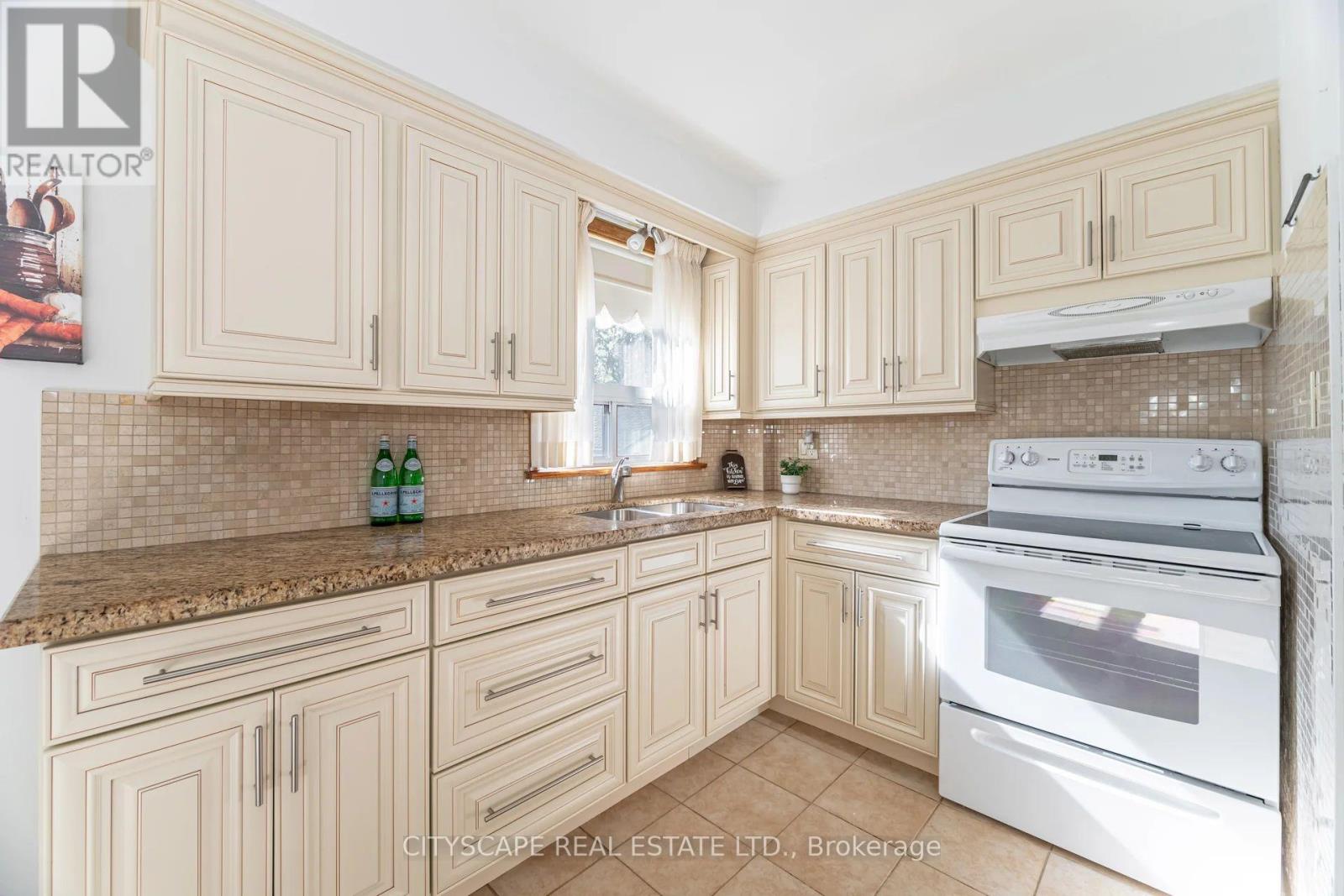 A kitchen with a white oven and cabinets.