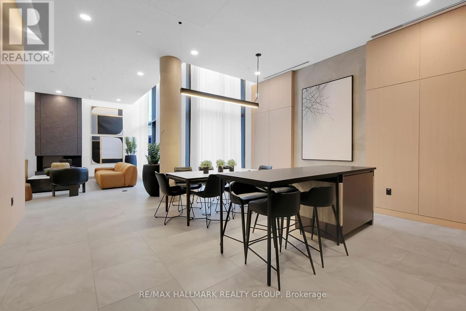 A modern dining room with a large table and chairs.