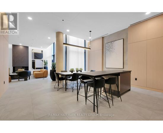 A modern dining room with a large table and chairs.