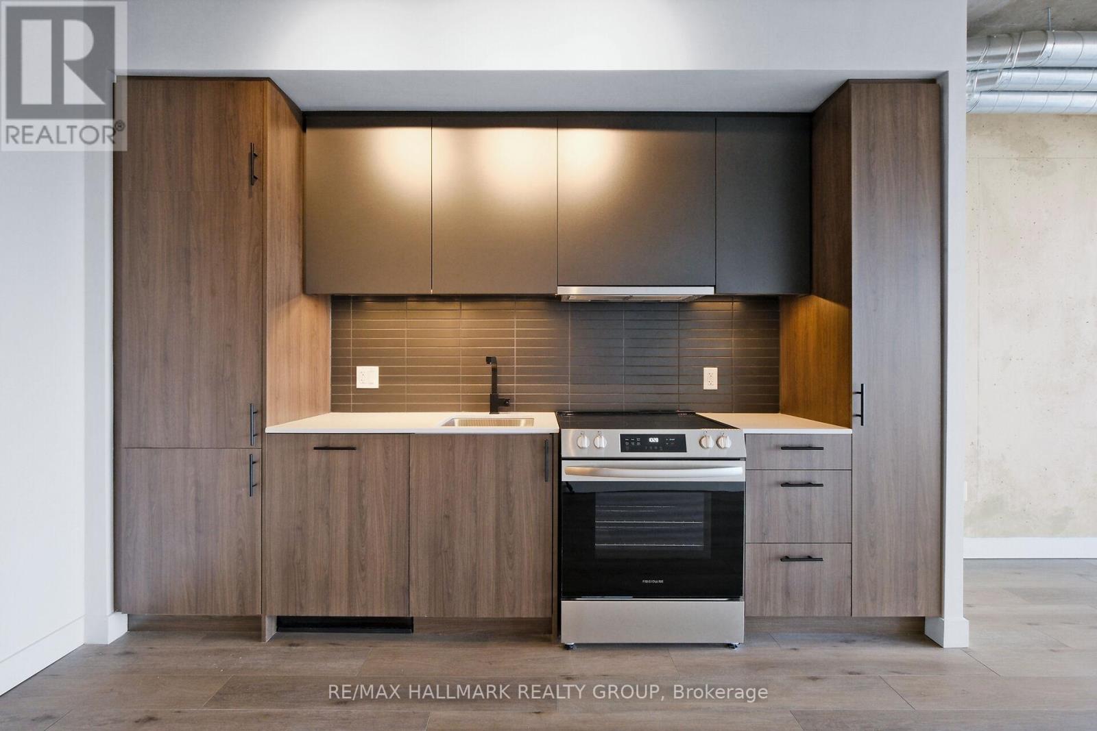 A modern kitchen with wooden cabinets and a stainless steel oven.