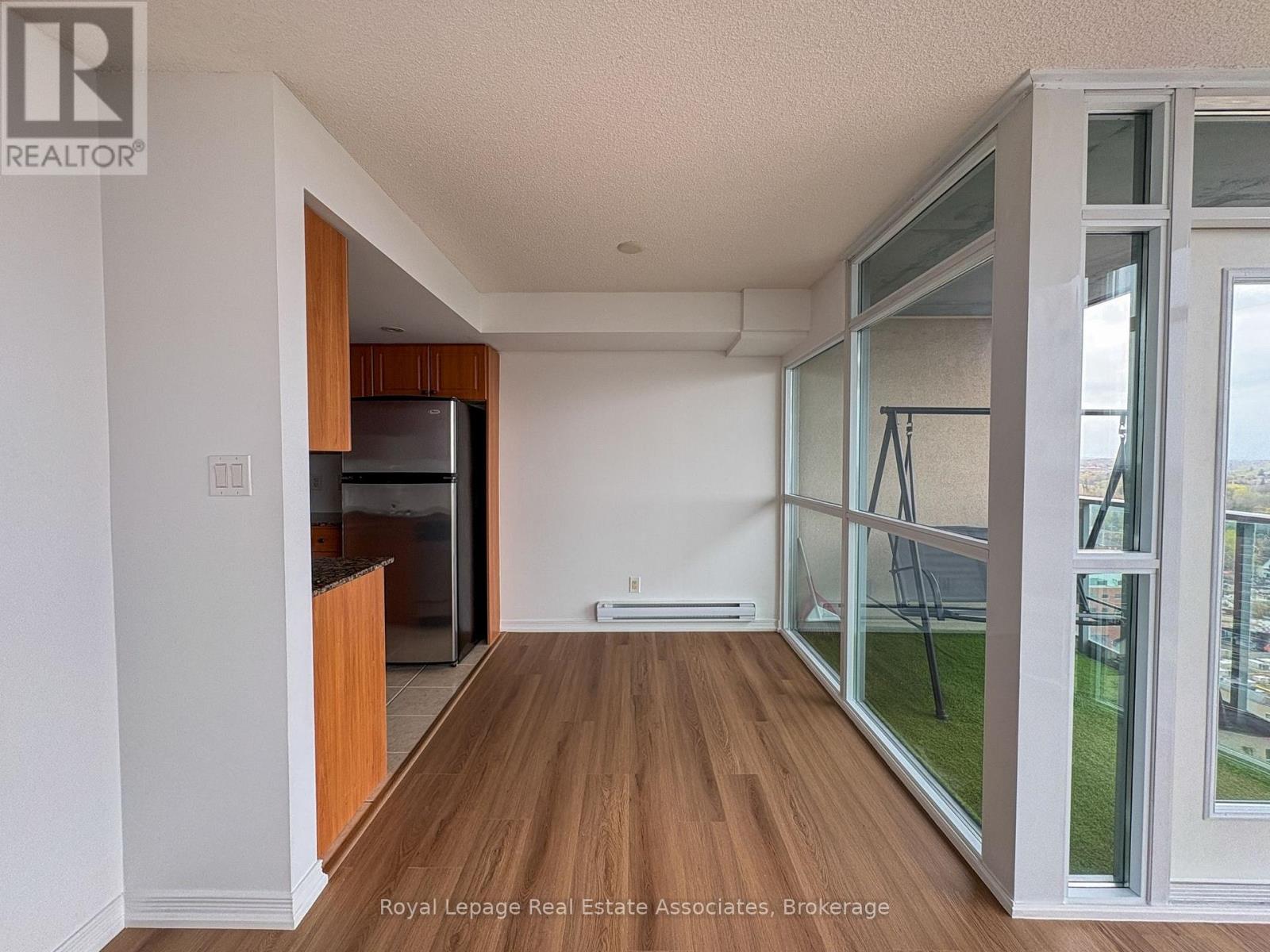 A bedroom with a bed, a window, and a wooden headboard.