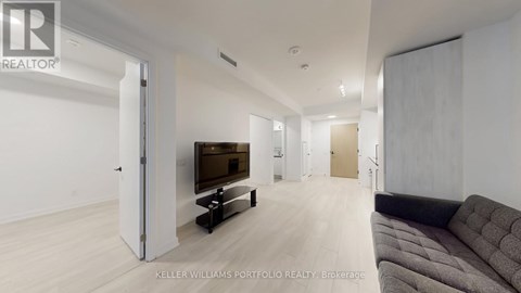 A living room with a couch and a television set.