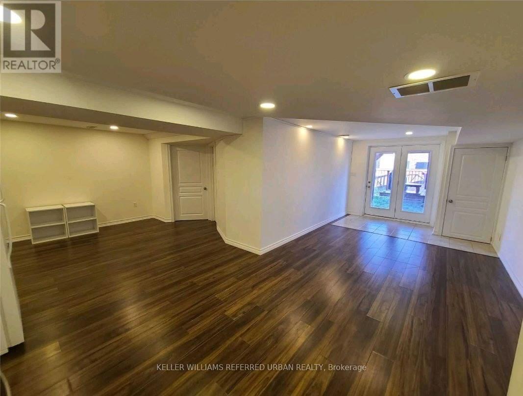 A room with wood flooring and white walls.