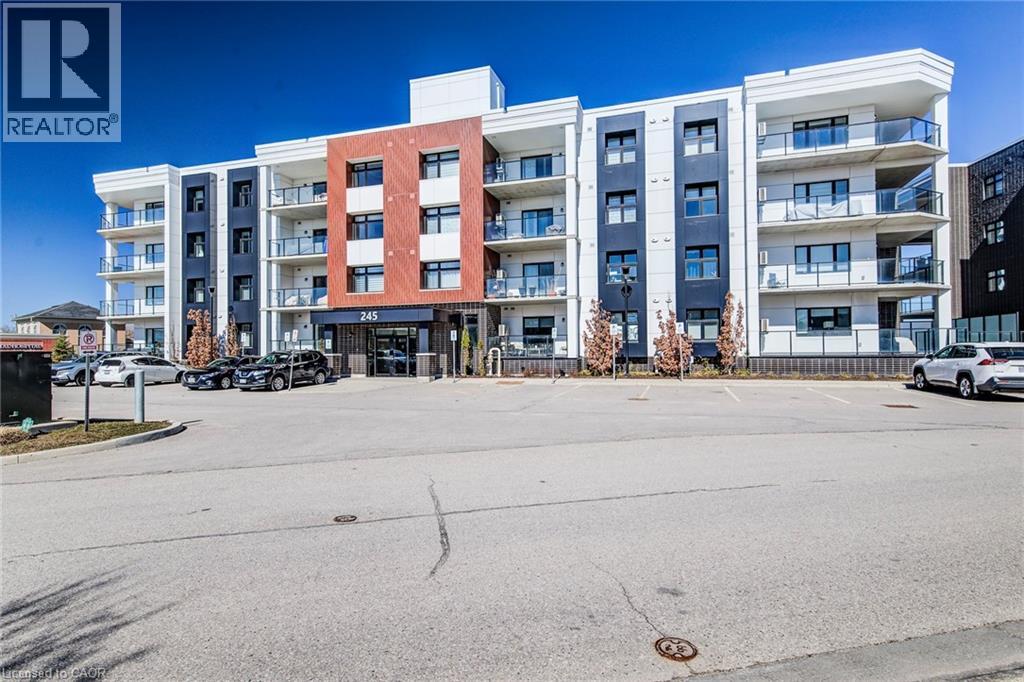 A large apartment complex with a parking lot in front.
